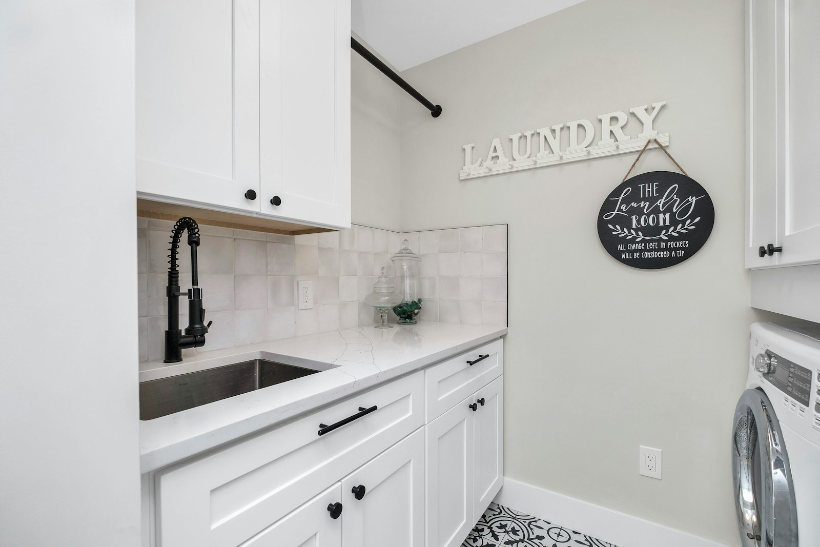 Laundry area with a sink, washer and dryer set up side by side
