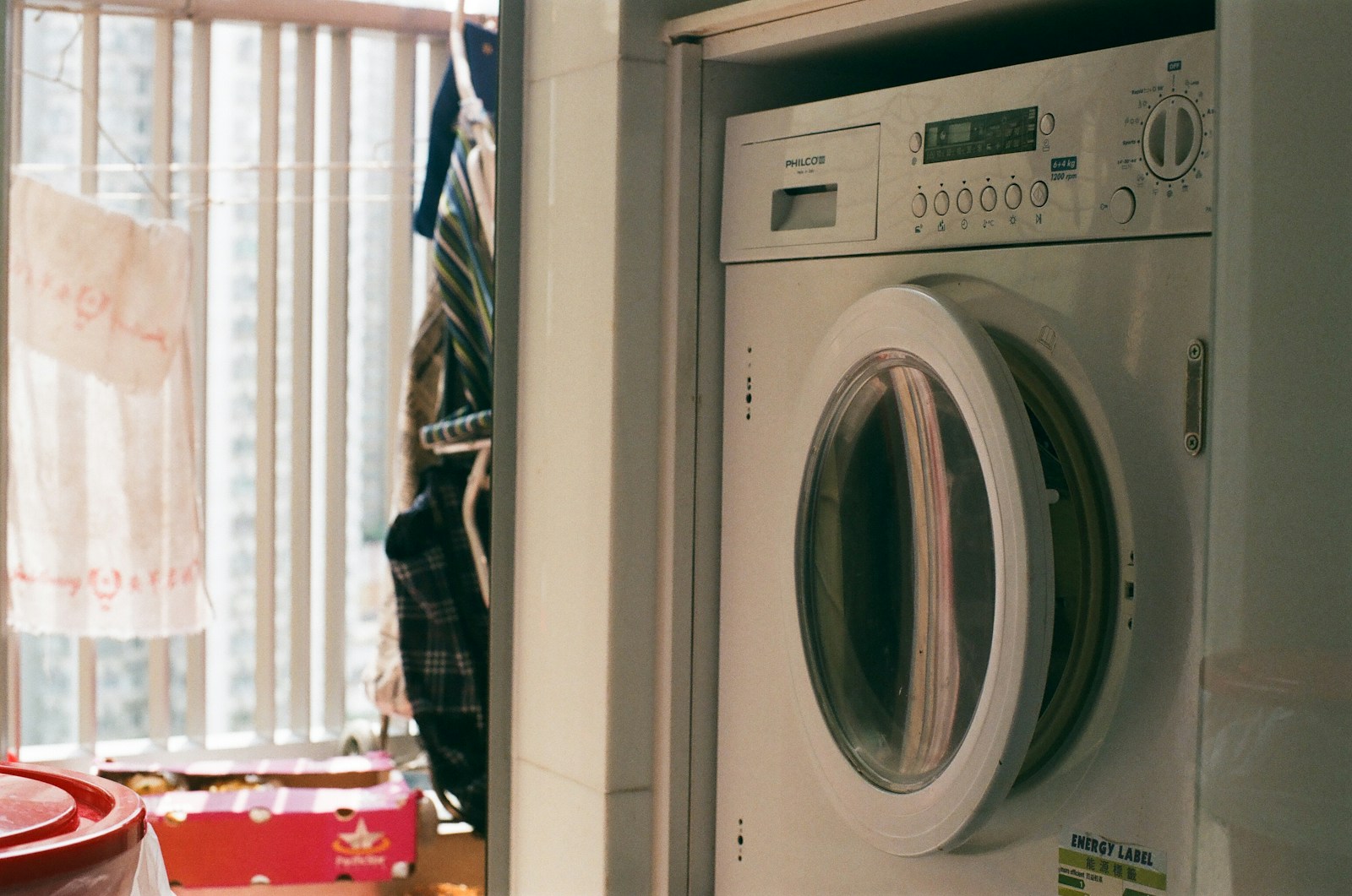 White front-load washing machine ready for installation in a home